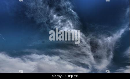 Dramatic cirrus cloud formation against deep blue sky, photographed in Greece and processed in post for tonal clarity and contrast. Suitable for weath Stock Photo