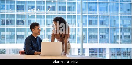 Busy happy diverse business team colleagues using laptop working in office. Stock Photo