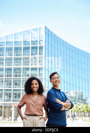 Portrait of young happy professional team of two diverse business man and woman. Stock Photo
