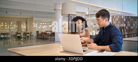Diverse team professional employees working together on computer in office. Stock Photo
