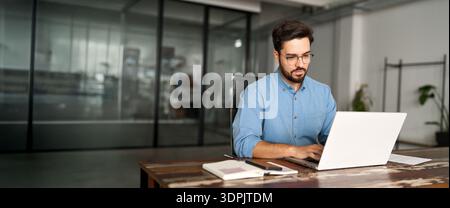 Busy professional business man company employee using laptop working in office. Stock Photo