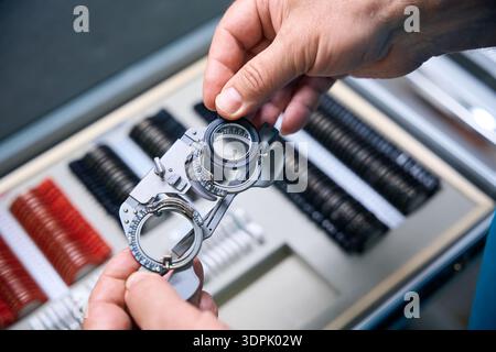 Ophthalmologist holding the trial lens frame from a set of other tools Stock Photo