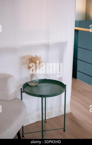 A table with dry flower in a vase, decoration in the cafe Stock Photo