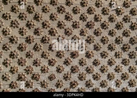 Close up of ancient wooden door with decorative star shaped metal studs Stock Photo