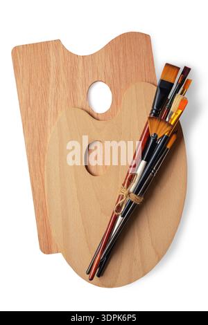 Art palettes and different types of paintbrushes. Isolated on white Stock Photo