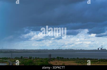 Gloomy rainy clouds hung over the city and the lake Stock Photo