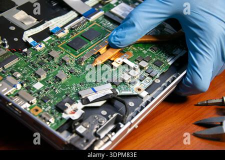 The technician is repairing the laptop. Stock Photo