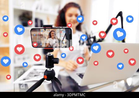 Podcast recording session with audience engagement on a mobile device at home studio Stock Photo