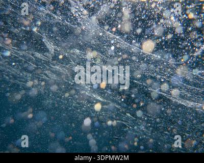 Air bubbles under the sea surface off the coast of Meganisi island in the Ionian Sea, Greece. Stock Photo