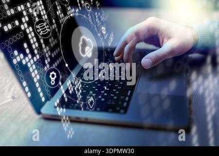 Person using a laptop with cloud computing icons in a modern workspace during day time Stock Photo