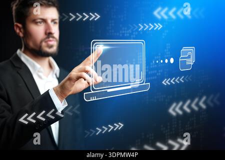 Man interacts with virtual screen showing computer and data transfer in modern office setting Stock Photo