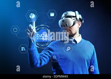 Virtual reality user interacts with data storage display in technology setting Stock Photo