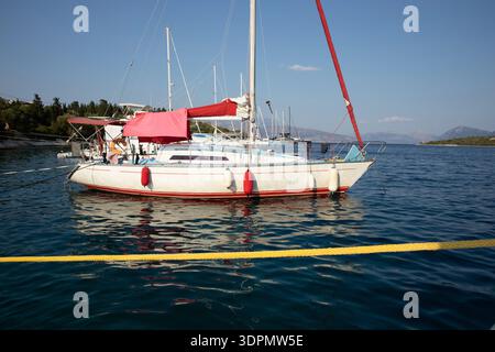 Moored sailboats on the coast of Atherinos Bay, Meganisi island, Ionian Sea, Greece in summer. Horizontal. Stock Photo