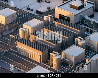 Data center rooftop showing cooling and ventilation systems, network infrastructure, and compute grid, Warszawa, Województwo mazowieckie, Poland. Stock Photo