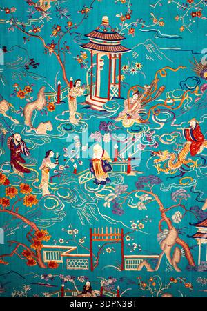 Turquoise Asian-inspired textile illustration with pagoda, figures, cranes, blossoms and swirling clouds; ornate vintage decorative fabric pattern. Stock Photo