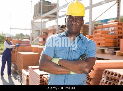 Portrait of a concentrated african american man worker standing in a warehouse Stock Photo