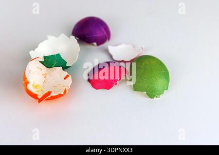 Colorful cracked easter egg shells on white background with copy space. Soft focus Stock Photo