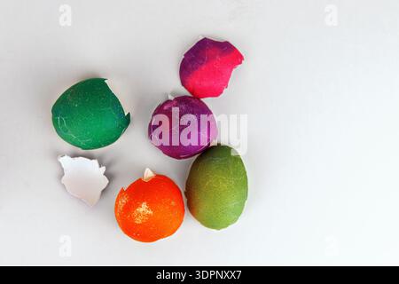 Colorful cracked easter egg shells on white background with copy space. Soft focus Stock Photo