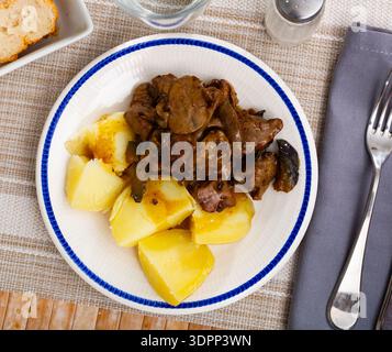 Fried rabbit liver served with boiled potato Stock Photo