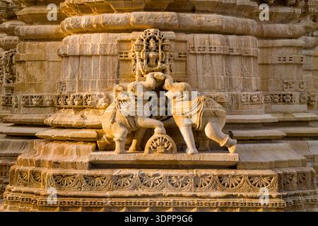 Chittorgarh, India - March 21, 2022: The image shows a close-up of an intricately carved stone relief depicting two elephants facing each other on the exterior wall of the Jain Shvetambar Temple, with ornate architectural details and decorative patterns visible. Stock Photo