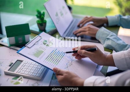 Analyzing green building performance metrics during business meeting. data analysis, green building, business meeting, sustainability, performance met Stock Photo