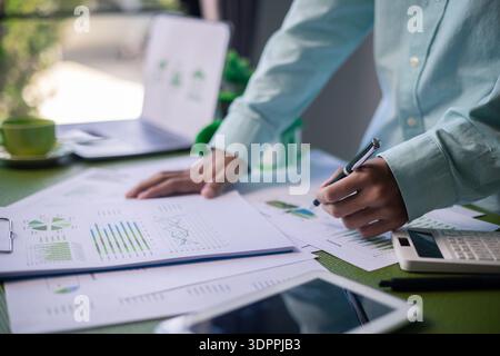 Analyzing green building performance metrics during business meeting. data analysis, green building, business meeting, sustainability, performance met Stock Photo