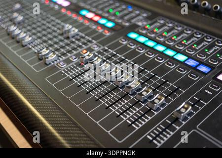Professional audio mixing console with lights, buttons, faders and sliders. Stock Photo