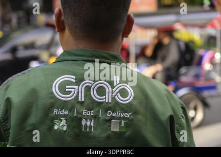 The Grab food delivery logo displayed on the shirt of a Grab delivery ...