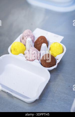 Colourful chocolate eggs are sorted in white cardboard packaging, chocolate quail eggs, Easter production, Haselstaller Hof, Gechingen, Germany Stock Photo