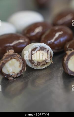 Halved chocolate eggs with creamy filling, arranged on a metal plate, Easter production of regional products, Haselstaller Hof, Gechingen, Calw distri Stock Photo