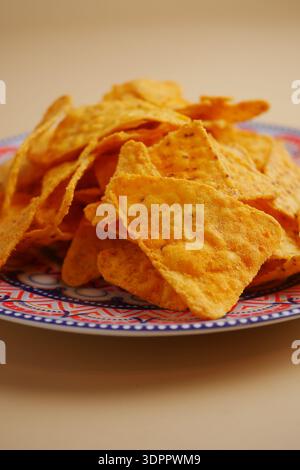 Crunchy nachos served on a colorful plate Stock Photo