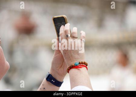 Female tourist's hands holding smartphone, hand and arm skin, close up Stock Photo