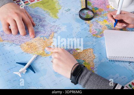 Planning a Trip With a Map and Travel Tools on a Table in a Bright Setting Stock Photo