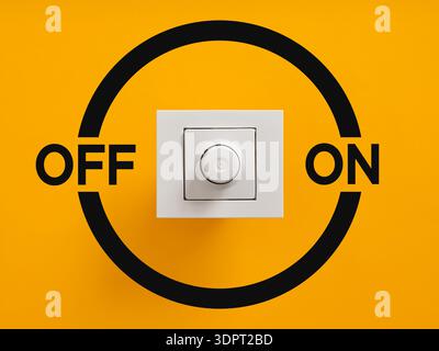 White dimmer switch centered on vibrant yellow background, modern control for adjusting light levels and power in contemporary interiors. Turning on o Stock Photo