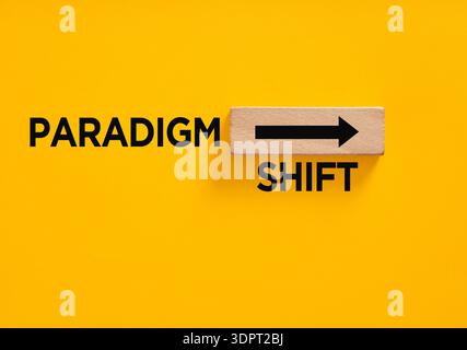 Paradigm shift text with an arrow on a wooden block, symbolizing change, innovation, and moving forward in business or science Stock Photo