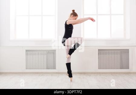 Young Dancer Practices Ballet in a Bright Studio During the Morning Hours Stock Photo