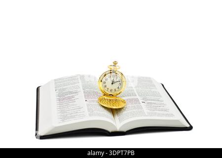 Pocket watch on a open Holy Bible with a white background. Copy space above. Stock Photo