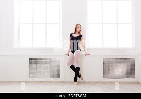 Young Dancer Practices Ballet in a Bright Studio During Daytime Hours Stock Photo