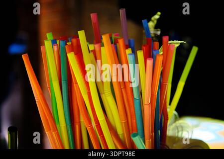 Colorful Plastic Drinking Straws in Bar Setting Stock Photo