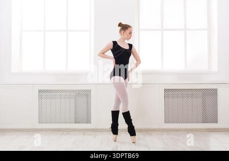 Ballet Dancer Practices in a Bright Studio With Large Windows During the Day Stock Photo