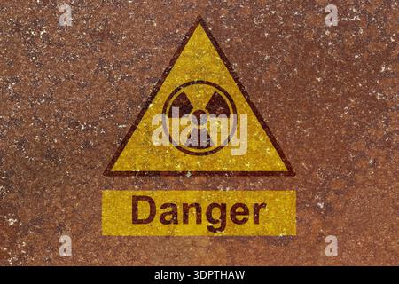 Danger radiation symbol sign on a rust background. Hazardous radiation danger risk concept. Stock Photo
