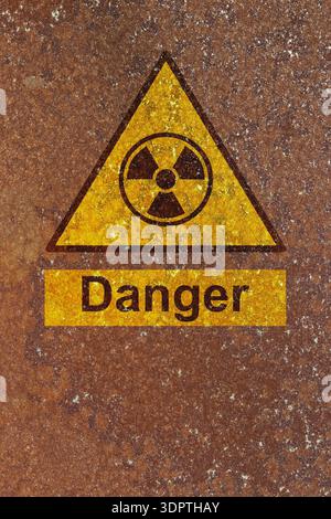 Danger radiation symbol sign on a rust background. Hazardous radiation danger risk concept. Stock Photo