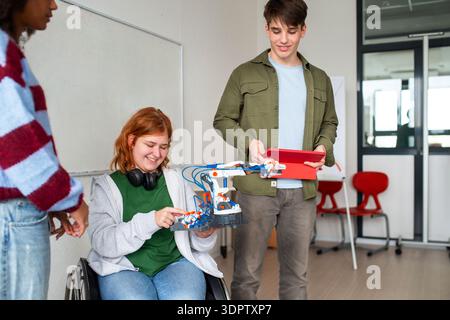 Inclusive student team presenting technology project in class. Stock Photo