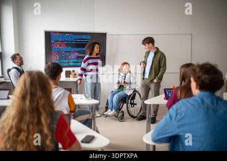 Inclusive student team presenting technology project in class. Stock Photo