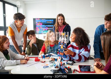 Diverse group of students working on engineering school project. Stock Photo