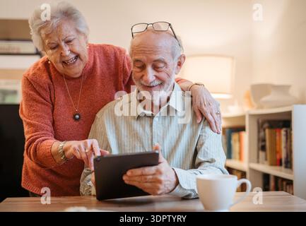 Senior coule working with tablet, having problem with technology. Stock Photo