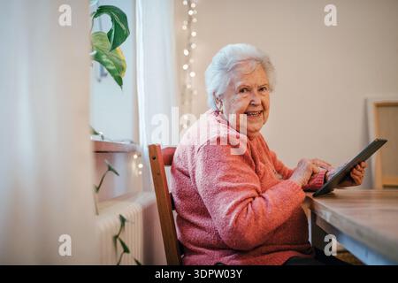 Older woman using tablet, shopping online. Stock Photo