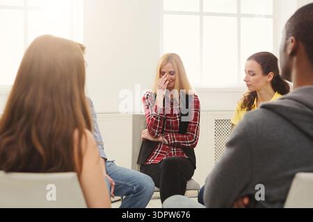 Group Discussion Takes Place at a Support Meeting in a Bright Room During the Afternoon Stock Photo