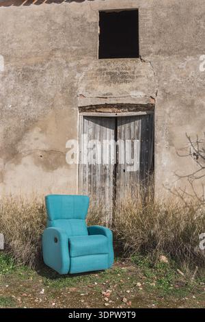 Leather recliner armchair in rustic shabby chic interior setting Stock Photo