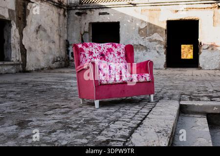 Modern upholstered furniture placed in front of weathered ruins Stock Photo